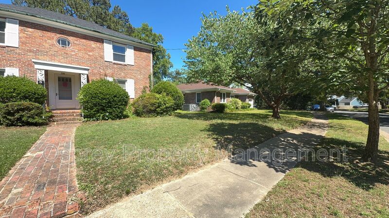 Charming 2BR with Sunroom, Hardwood Floors & Lawn Care Included - Photo 2