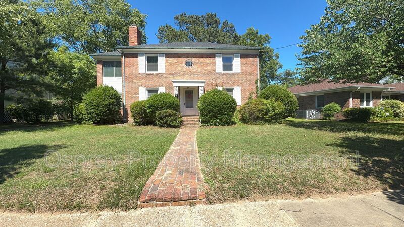 Charming 2BR with Sunroom, Hardwood Floors & Lawn Care Included - Photo 1